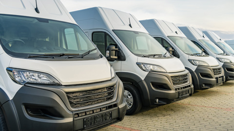 Row of grey vans parked up