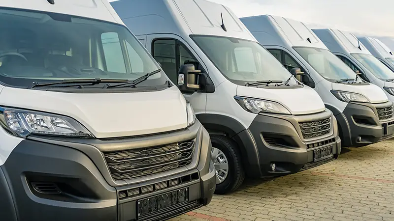 Row of grey vans parked up